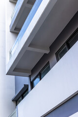 Modern architecture building with glass balconies and minimalist design