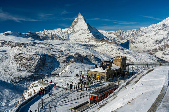 Gornergrat Matterhorn railway red train with mountain peak. Zermatt, Canton of Valais, Switzerland.