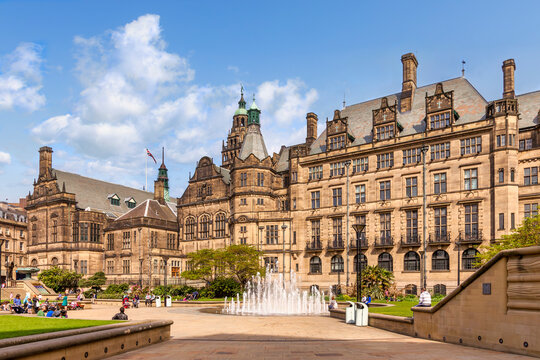 Sheffield Town Hall and Peace Gardens on a sunny spring day, people relaxing in the square, fountain playing, beautiful.