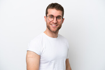 Fototapeta premium Young caucasian man wearing band aids isolated on white background smiling a lot