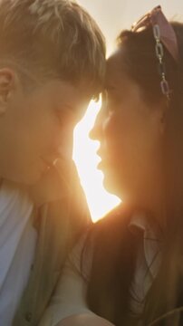 Young couple sharing intimate moments at sunset