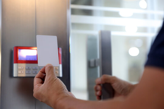 Hand scanning proximity ID card on reader access control system to security door unlock with identity or verification identify icons for safety detect fingerprint scan or check attendance.