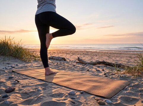 Woman Practicing Yoga Pose on Beach at Sunset with Ocean Background