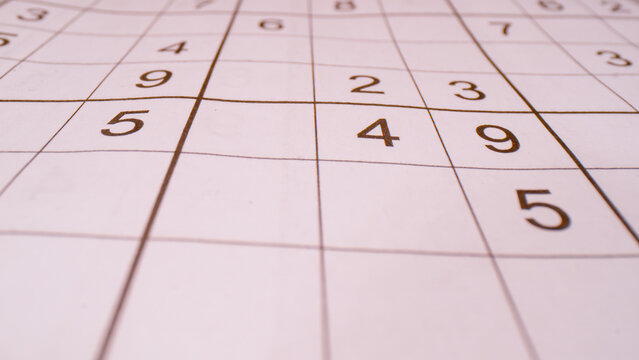 CLOSE UP, BOKEH: Detailed view of grid and numbers in sudoku number puzzle