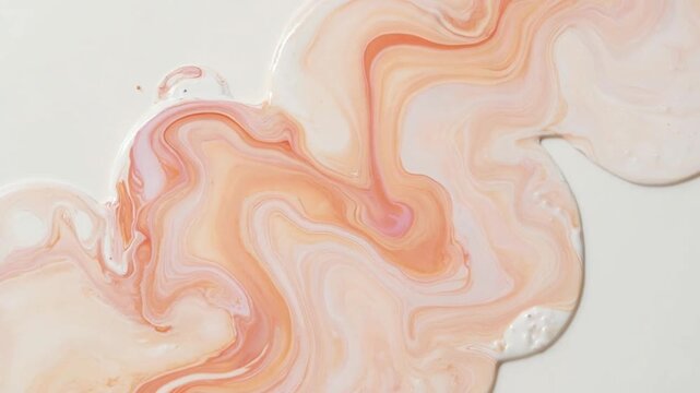 Abstract fluid marble texture background with peach and pink swirls on white