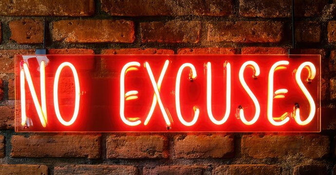 Bright red neon sign displays no excuses against textured brick wall. Dramatic lighting creates strong visual impact.