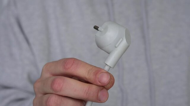 A charging cable for electrical appliances.
An electrical plug on a gray background