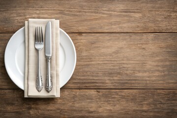 Elegant table setting with vintage cutlery on a white plate and beige napkin over rustic wooden background, perfect for dining concept visuals. Ai generative