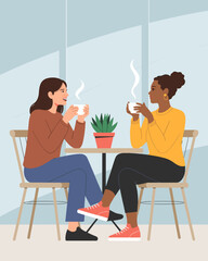 Two diverse young women enjoying coffee break in modern cafe happy friends talking and drinking hot beverages at table in relaxed atmosphere friendship and connection concept for lifestyle and social