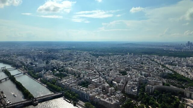 Aerial panoramic view of paris skyline from above showing the seine river, trocadero gardens, and the la d&eacute;fense district on a beautiful summer day with some clouds