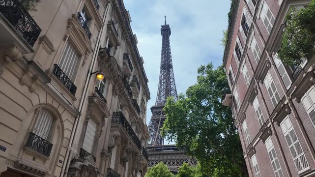 Romantic parisian street view with the iconic eiffel tower in the background, a famous landmark of france. Smooth camera tilting up, revealing the cityscape and architecture