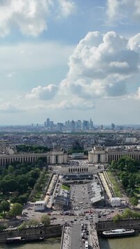 Paris aerial cityscape with the seine winding through dense haussmann buildings and multiple bridges, iconic landmarks and rooftops under a clear summer sky, no people visible