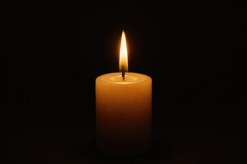 Thick pillar candle burning with a bright flame in a dark, featureless background