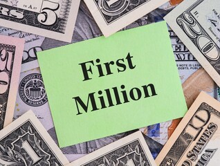 Green paper note with phrase First Million on a United States Dollar bills background
