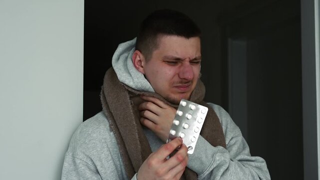 Cough drops for a fighting guy.
A man with a sore throat.
Colds and their treatment with pills.
Painkiller pills in blister packs.