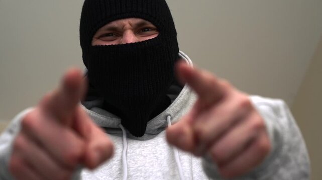 A gangster in a black mask.
A bandit with a covered face.