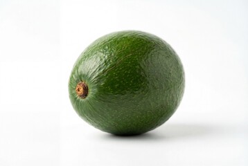 Single ripe green avocado with smooth skin and stem