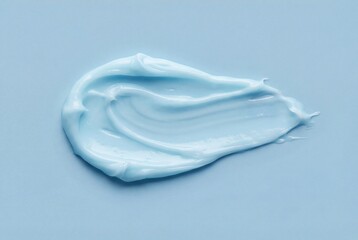 Light blue cosmetic cream smear texture on matching blue background showing glossy moisturizer swatch