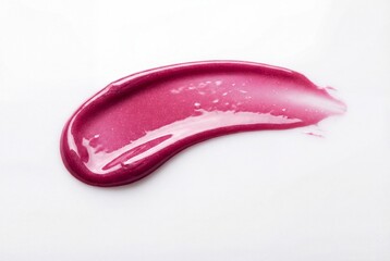 Lustrous magenta cosmetic lip gloss smear isolated on white background displaying glossy texture