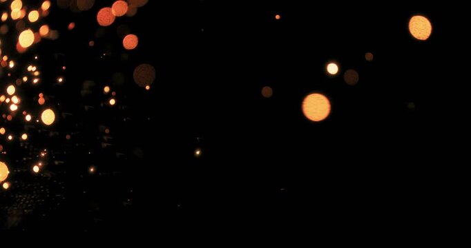 This captivating video features shimmering metal sparks on a deep black background, ideal for motion graphics and special effects, enhancing visual appeal in diverse design projects