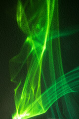 Abstract green laser light beams and shapes for futuristic tech or party background