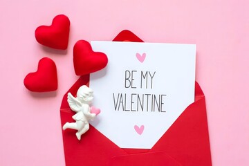 Fototapeta premium Red envelope, white writing paper, hearts, Cupid on pink background Happy Valentine's day concept.