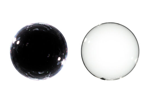 Two contrasting orbs one dark and reflective, one clear and transparent isolated on white background
