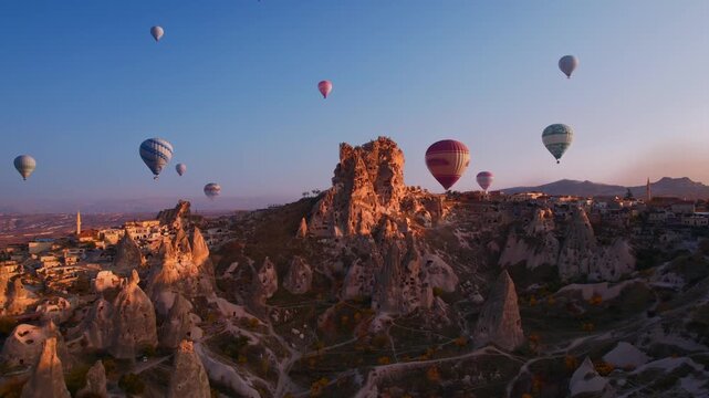Aerial view Hot air balloons over Ancient Uchisar castle, underground city of Cappadocia Turkey, Goreme national park.
