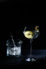 Cocktail with lemon and ice bucket bar setup