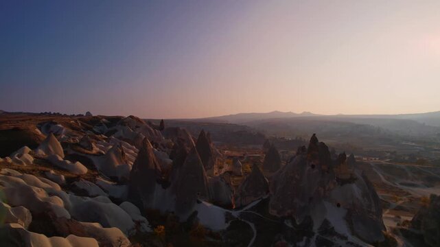 Aerial view landscape journey over Cappadocia Turkey majestic rock formations rock formations from tuff at golden hour.