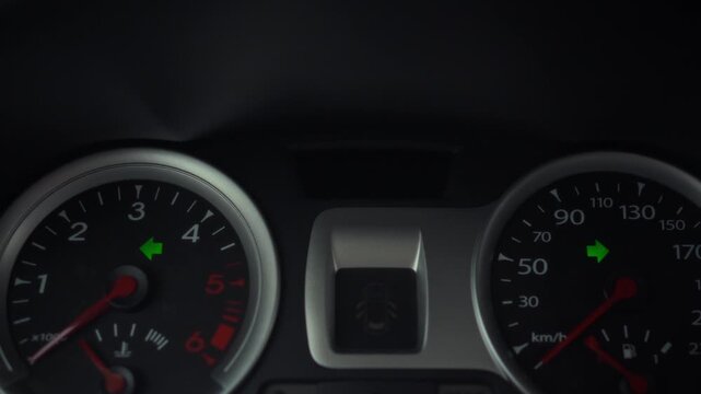 Inside the vehicle, the driver's hand switches off the hazard signal mode on the dashboard, yet the arrow indicator lights persist in blinking, a contradictory visual signal