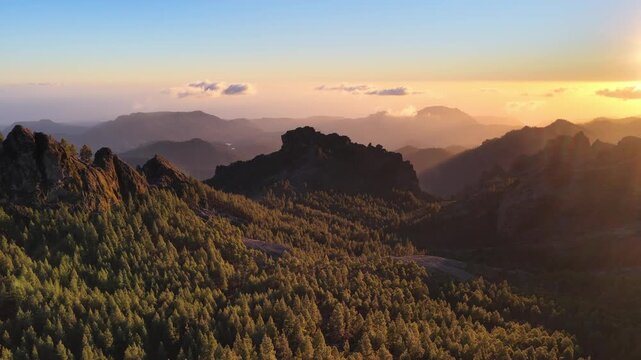 drone flying in Gran Canaria volcanic mountain landscape, sunset aerial view of Roque Nublo in Gran Canaria, Canary Islands, Spain, adventure holiday in Gran Canaria