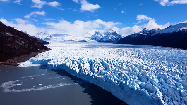 Los Glaciares National Park In El Calafate Santa Cruz Argentina. Stunning View Of Icebergs Breaking Off Into The Water . Outdoor Tourism Icon Patagonia Glacier. Snow Covered High Angle View.