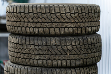 A stack of winter tires stacked on top of each other