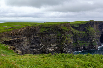 a rainy and stormy summer day at the famous cliffs of moher in the irish County Clare