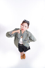 Young Woman's Playful Pose: A fashionable young woman strikes a cute pose, with a touch of elegance, capturing a moment of playful charm. The scene is bright and cheerful.