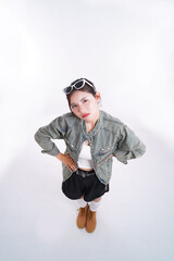 Stylish Woman Posing: Capturing an overhead view, a stylish woman stands confidently, wearing sunglasses and exuding a chic vibe, her gaze intense and captivating.