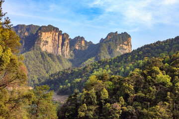 Zhangjiajie national forest park. A mountain range with a clear blue sky and a few clouds