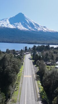 Patagonia Road At Puerto Octay Los Lagos Chile. Breathtaking Aerial View Of Busy Traffic In A Freeway Road. Outdoor Travel Patagonia Glacier. Outdoor Snow Covered Above View. Puerto Octay Los Lagos.