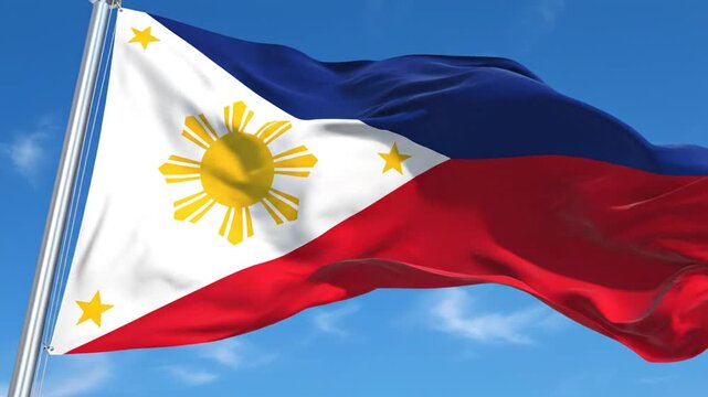 Philippine flag waving against a bright blue sky background
