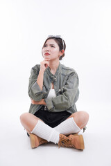 Introspective Thought: A young woman sits cross-legged, deep in thought, with a contemplative expression.