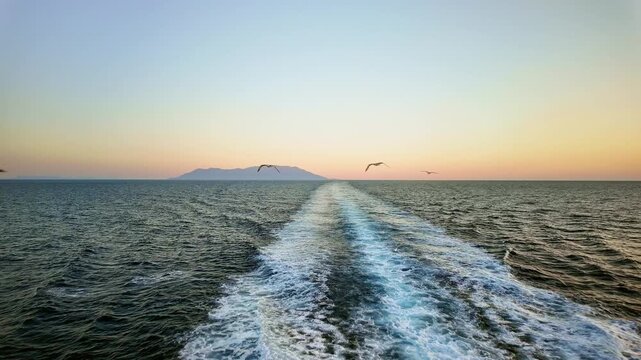 Seagulls Following Ferry Boat at Twilight Near Samothrace Island