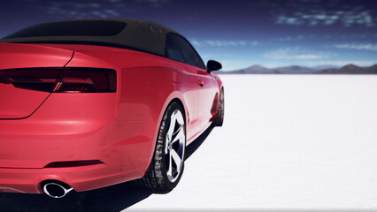 A striking red convertible stands alone on a vast, white salt flat. The sun shines brightly above, creating a stunning contrast with the rich colors of the car and the blue sky. © icetray
