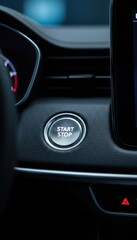 Vertical Close up of Silver Engine Start Stop Button on Dark Leather Dashboard with Blue Ambient Lighting and Sleek Interior Design