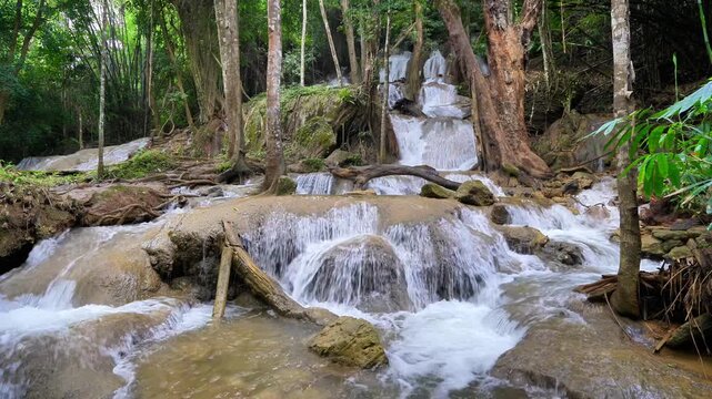 Pha Tat Waterfall, Kanchanaburi Province, Thailand. Video of a large waterfall in the middle of a lush green forest, with the sound of the waterfall. 4k