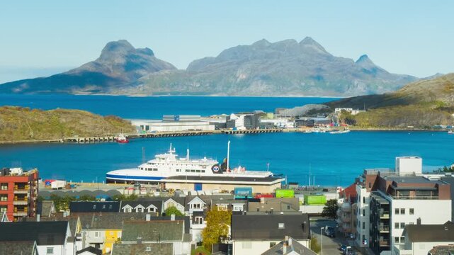 Bodo, Norway. View of the marina in the city center of Bodo, Norway with a fjord and a mountain in the background. Time-lapse during a sunny winter day