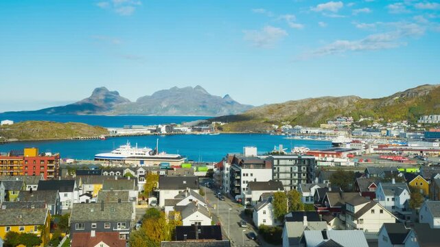 Bodo, Norway. View of the marina in the city center of Bodo, Norway with a fjord and a mountain in the background. Time-lapse during a sunny winter day