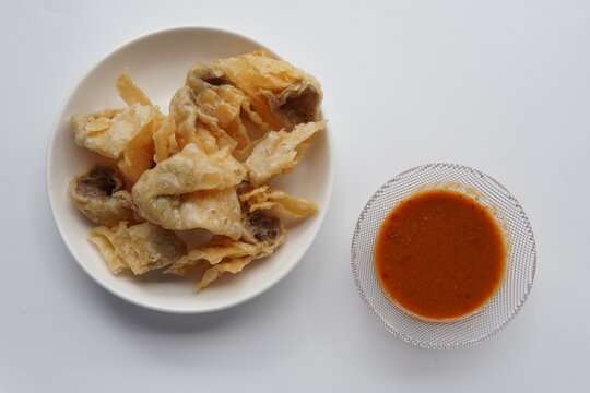 Crispy Batagor with Dipping Sauce. This traditional Asian snack is perfectly golden and crunchy, making it a popular appetizer.
