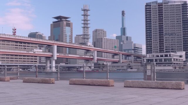 Static view of Kobe waterfront cityscape with moving traffic