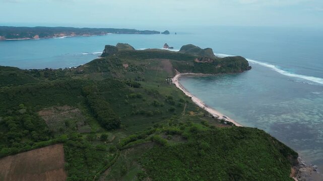 Aerial Reef Lagoon With Long Sheltered Bay, Clear Shallow Flats And Turquoise Channels, Gentle Breakers Along Outer Reef, Narrow Sandy Shoreline, Katil beach,Kuta,Lombok,Indonesia